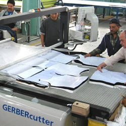 Fabric being cut in bulk for wholesale ethnic wear production